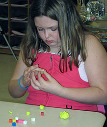Student examining cubes