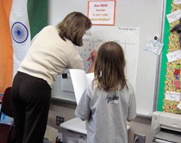 Teacher and student at whiteboard together