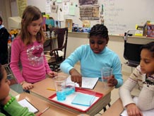 Students investigating three containers of water