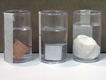 Three cubes in containers of water