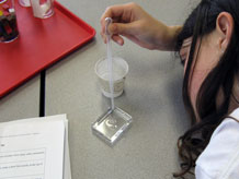 Student measuring 20cc of water