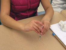 Student making drops on desk